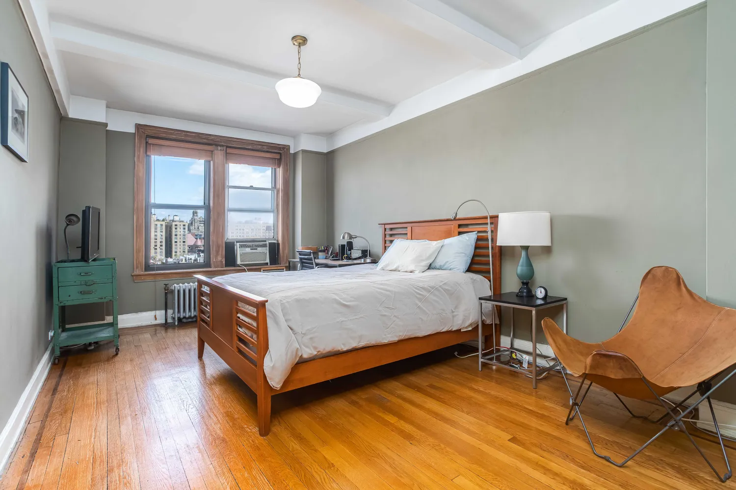 a bedroom with a bed and a chair