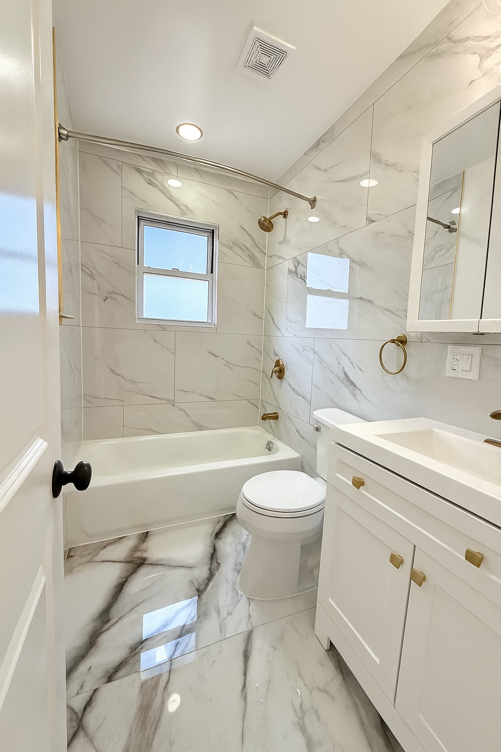 14 Vermont Court, Unit F Brooklyn, NY 11207 - Photo 4 of 10 a bathroom with a toilet a sink a mirror a bathtub and vanity