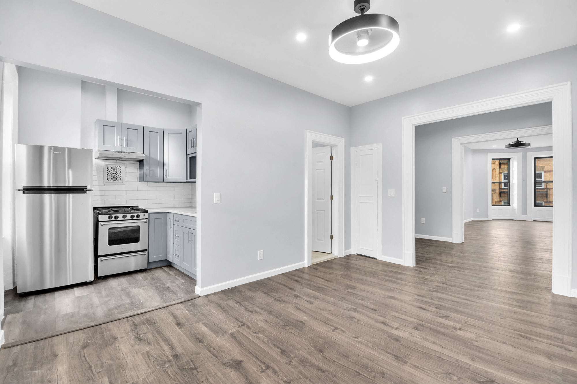 316 Lewis Avenue, Unit 2 Brooklyn, NY 11221 - Photo 5 of 8 a view of a kitchen with stainless steel appliances granite countertop a stove and a refrigerator