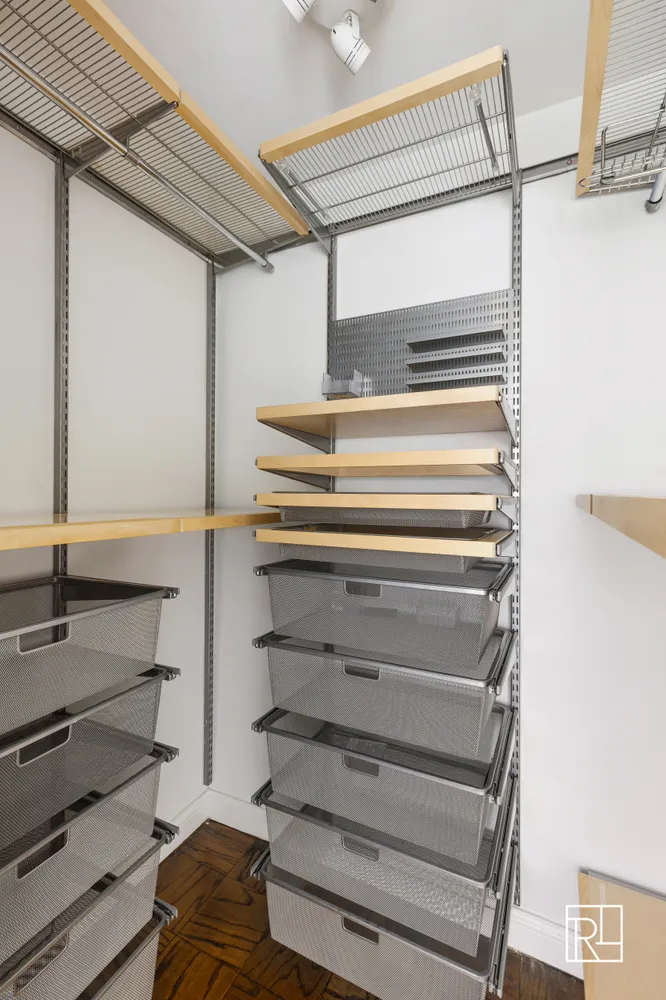 a view of closet with wooden floor