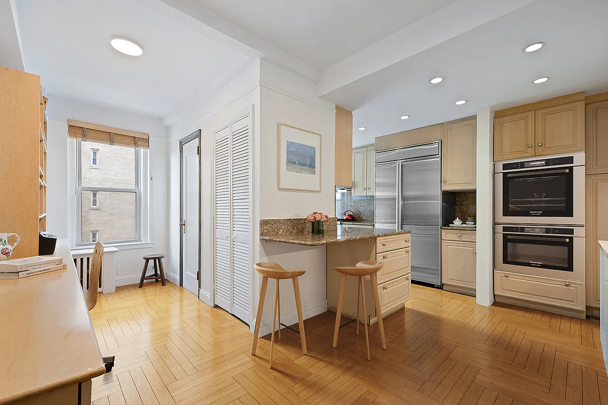 415 Central Park West, Unit 6A Manhattan, NY 10025 - Photo 11 of 25 a kitchen with stainless steel appliances granite countertop a refrigerator and a stove top oven