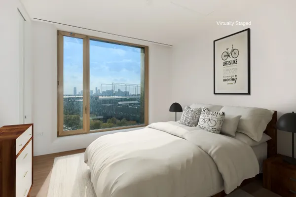 a bedroom with a bed and a large window