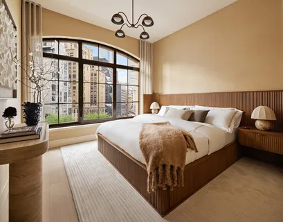 a bedroom with a large bed and a large window