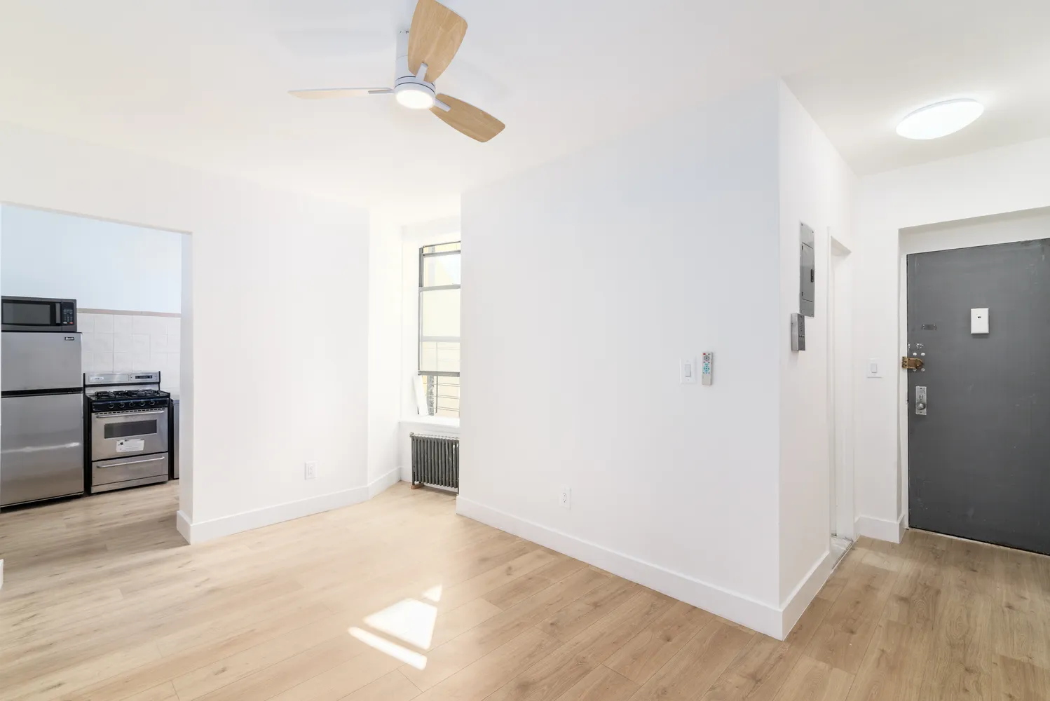 a view of a kitchen with a sink and a refrigerator