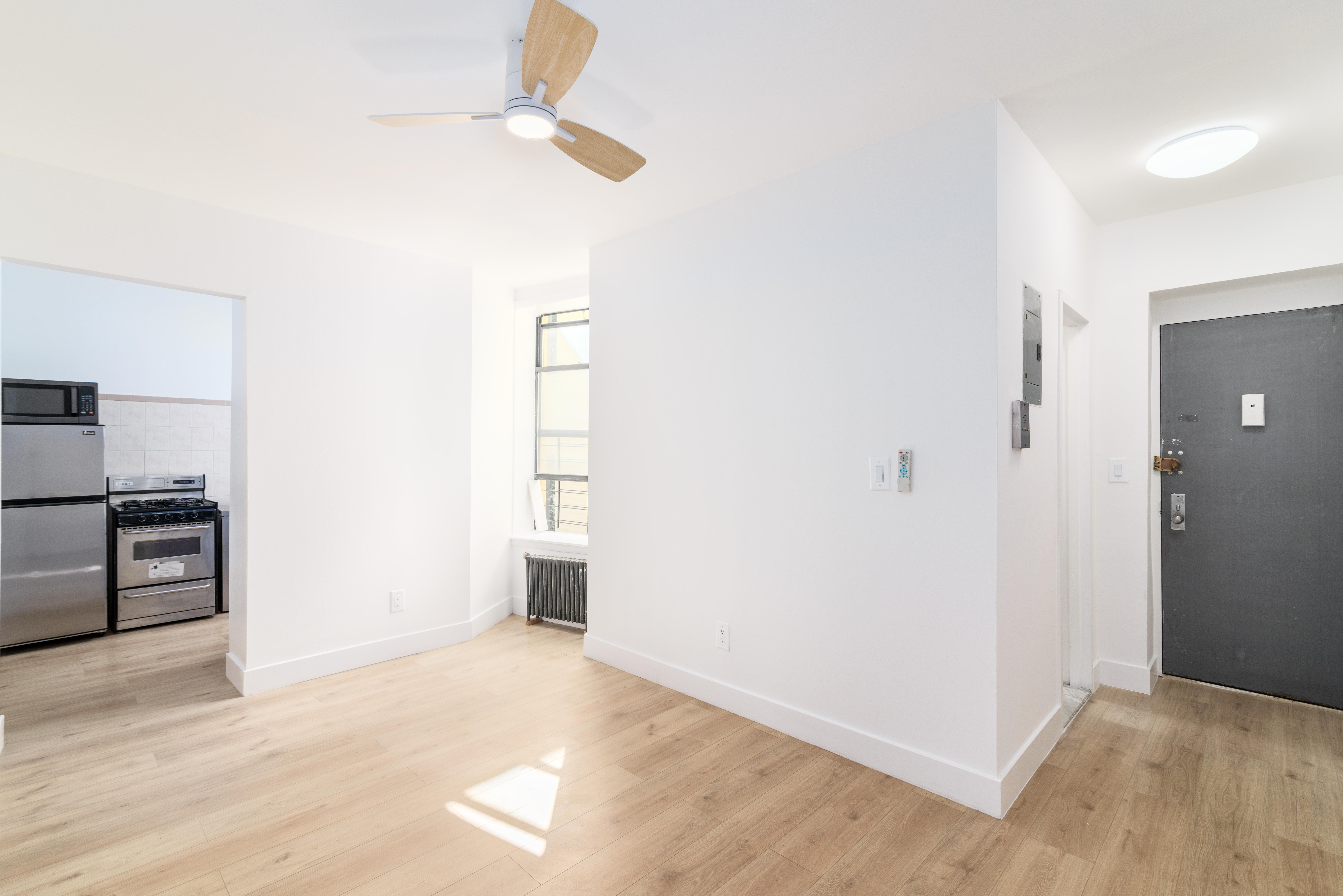 517 West 144th Street, Unit 9 Manhattan, NY 10031 - Photo 15 of 22 a view of a kitchen with a sink and a refrigerator