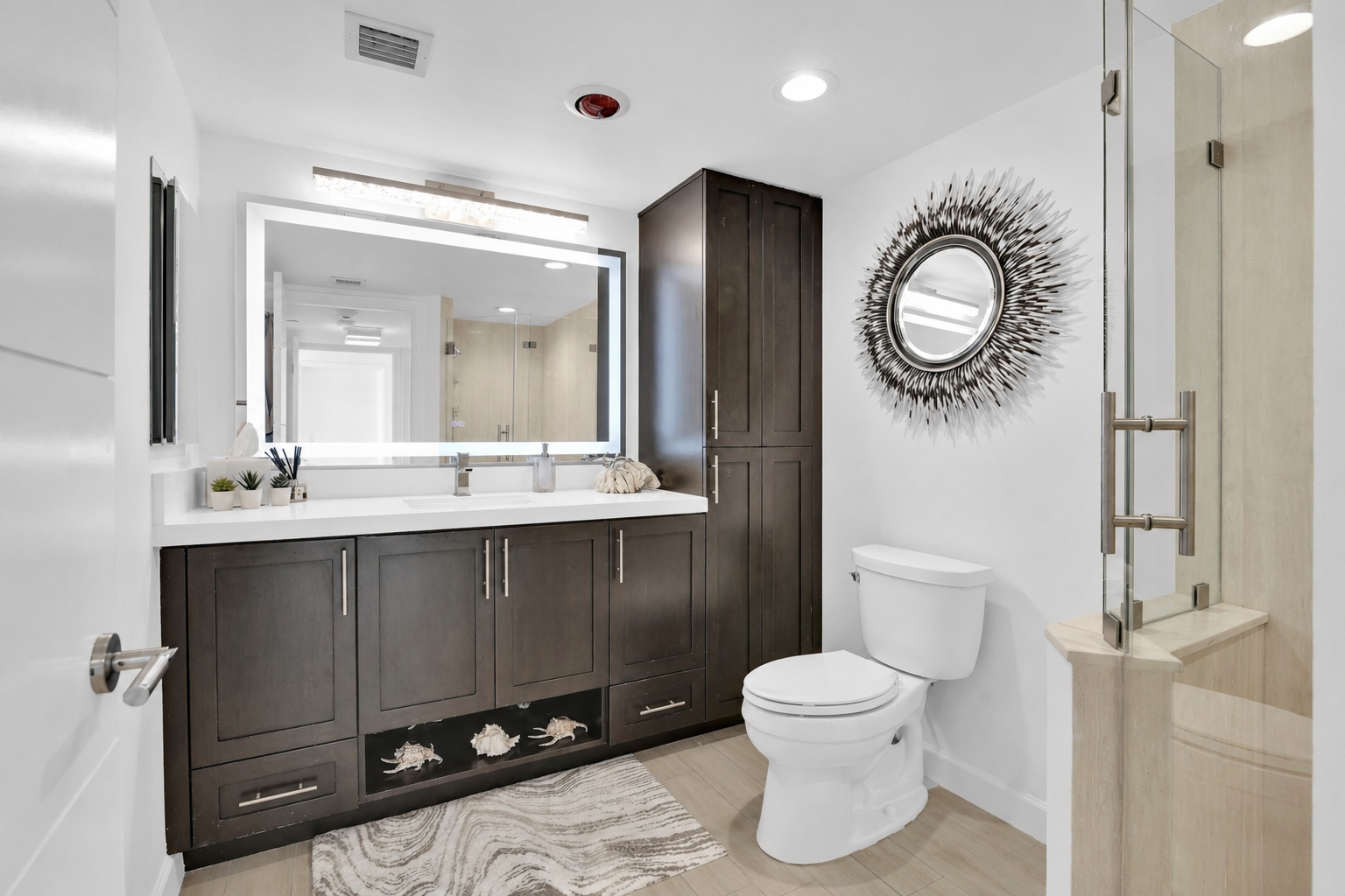 120 Southeast 5th Avenue, Unit 235 Boca Raton, FL 33432 - Photo 6 of 64 a bathroom with a toilet a sink and mirror