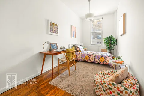a bedroom with furniture and a window