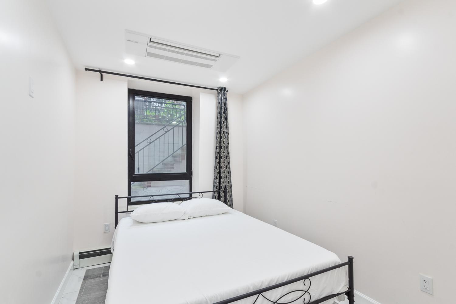 347 East 4th Street, Unit 3 Manhattan, NY 10009 - Photo 2 of 7 a bedroom with a bed and a window