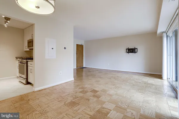 a kitchen with white cabinets and appliances