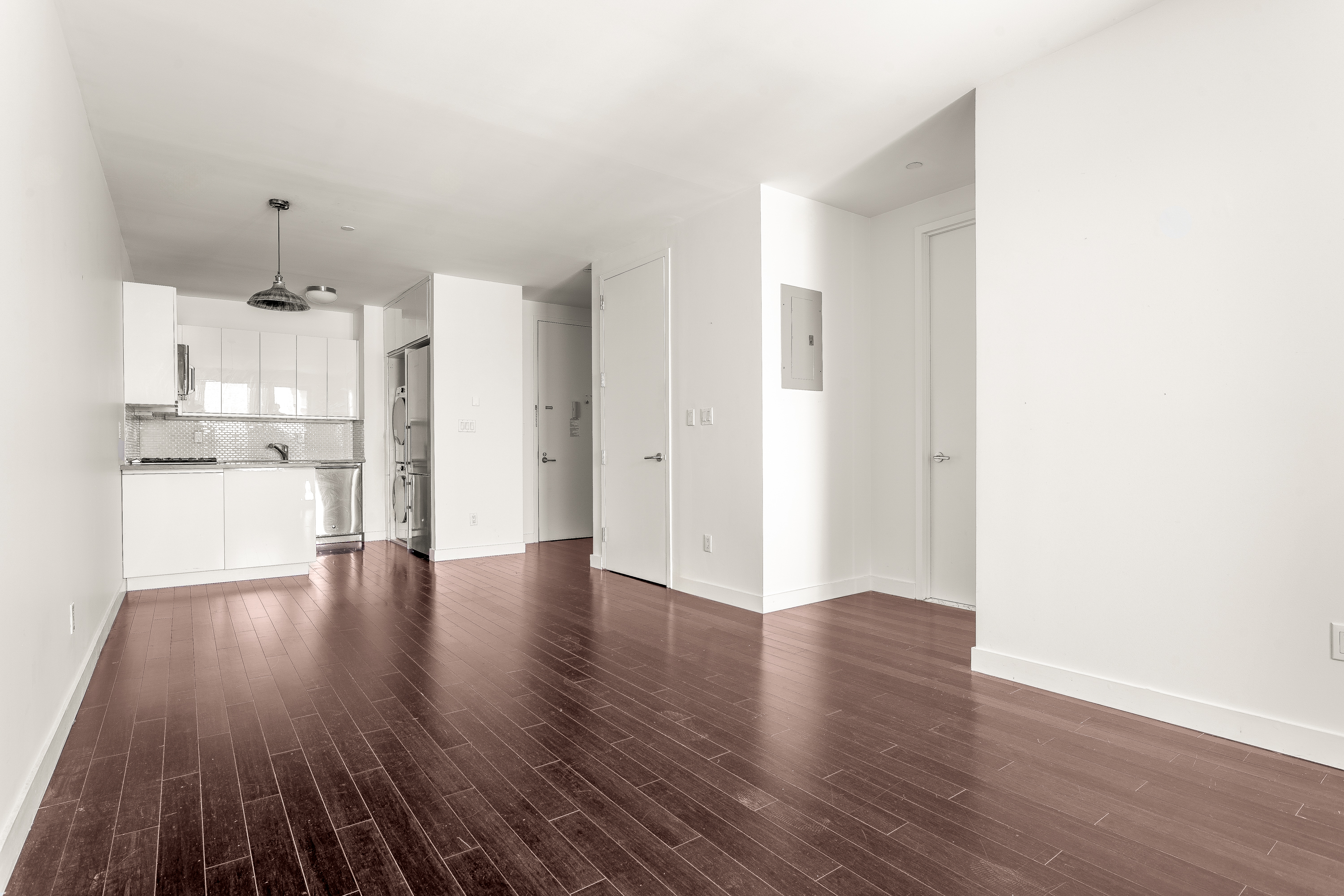 753 St Nicholas Avenue, Unit 2B Manhattan, NY 10031 - Photo 3 of 10 a view of a kitchen with wooden floor and electronic appliances