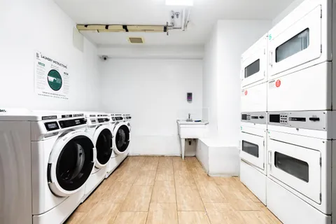 a view of washer and dryer with kitchen in the background