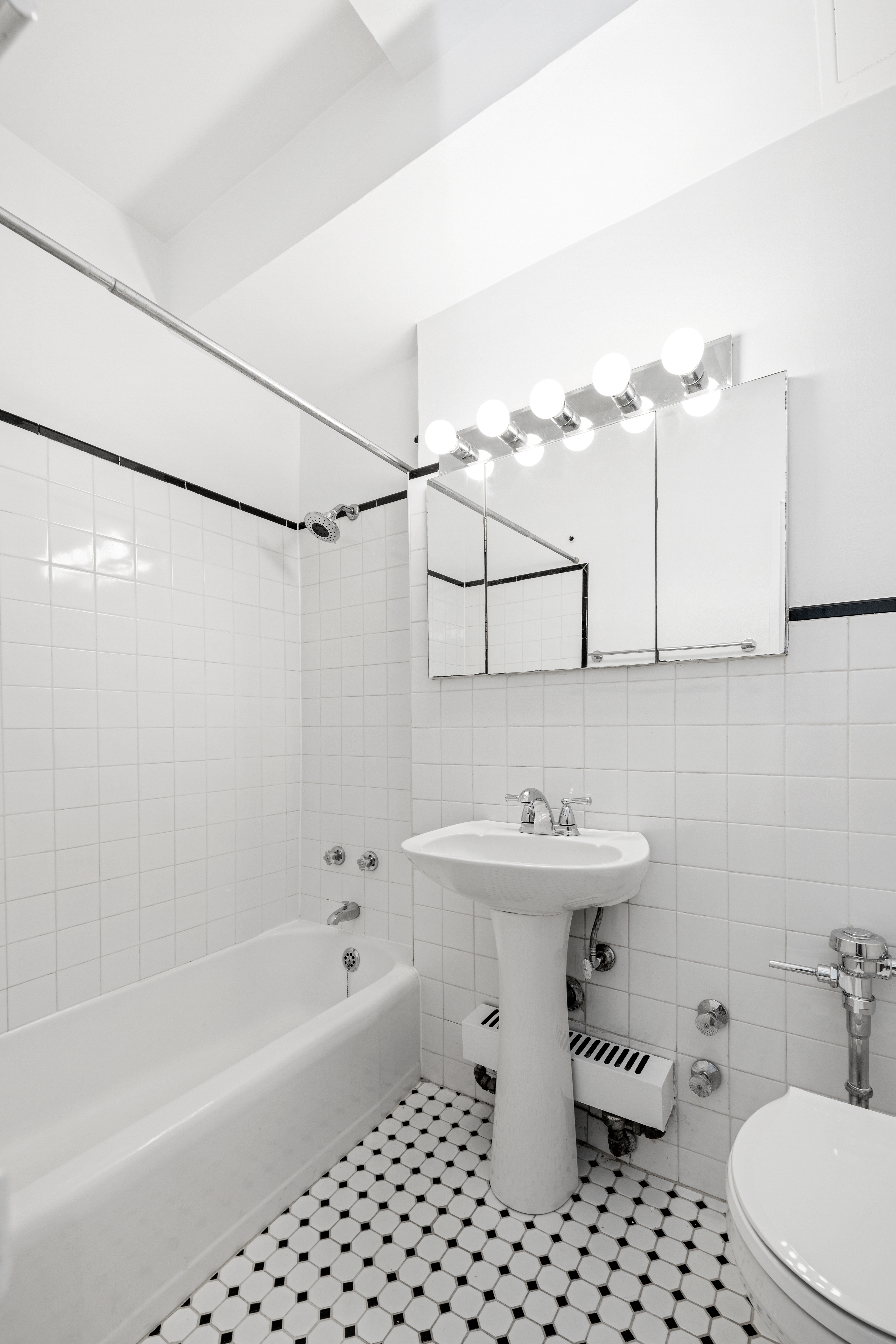 240 East 46th Street, Unit 8H Manhattan, NY 10017 - Photo 5 of 6 a bathroom with a sink a toilet and shower