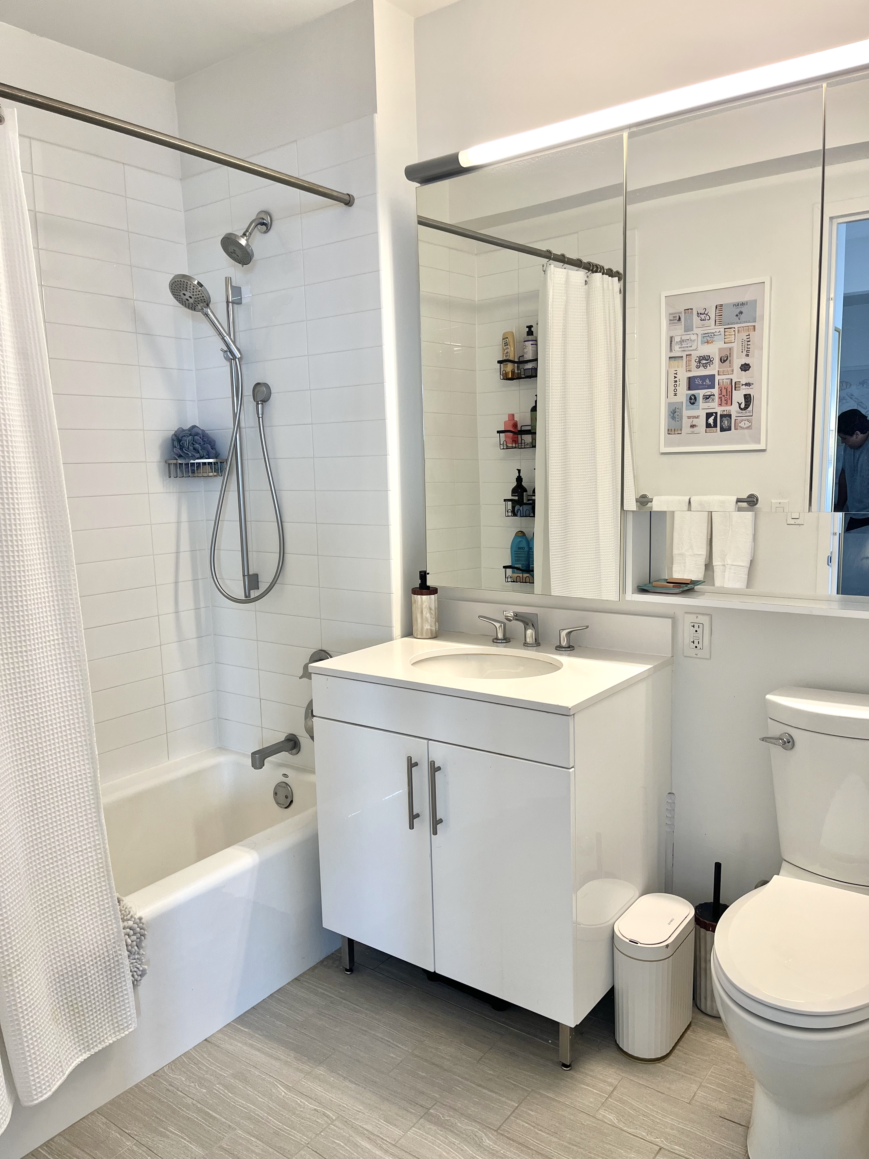 606 West 57th Street, Unit 1612 Manhattan, NY 10019 - Photo 5 of 18 a bathroom with a granite countertop sink toilet and shower