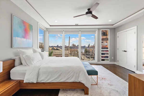 a bedroom with a bed mirror and window