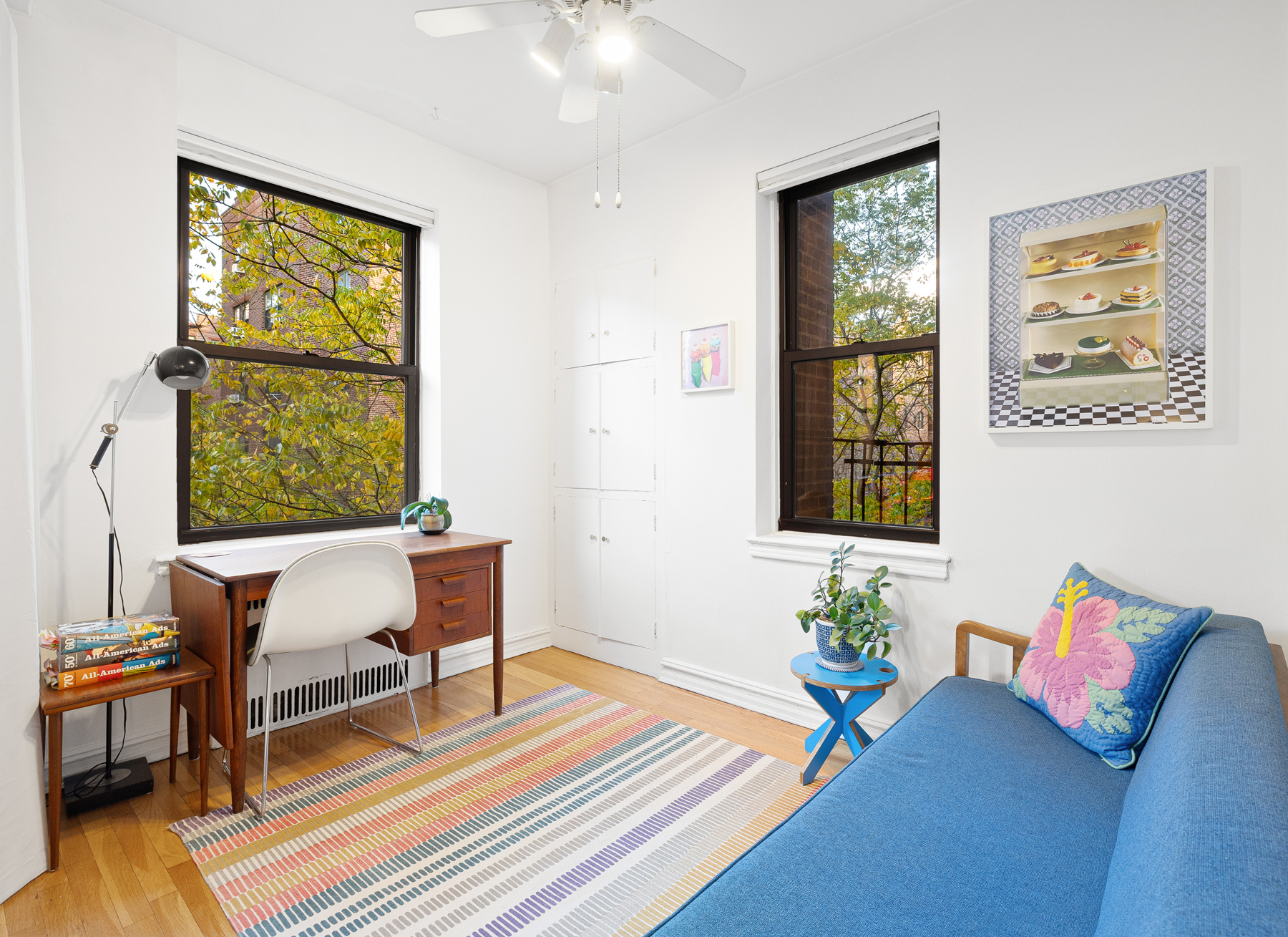 77-11 35th Avenue, Unit 3N Queens, NY 11372 - Photo 6 of 21 a living room with furniture and a window