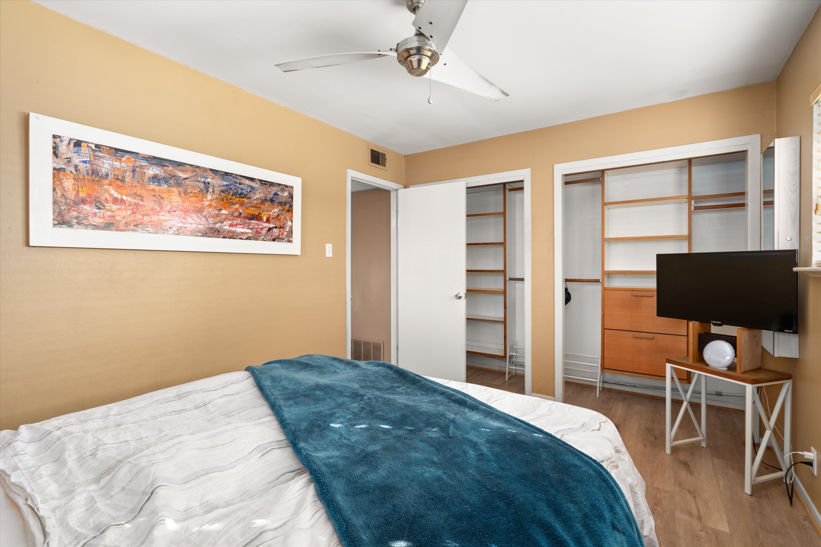 4614 Jinx Avenue Austin, TX 78745 - Photo 14 of 40 a bedroom with a bed and a flat screen tv
