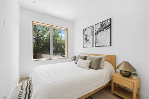 a bedroom with a bed and window