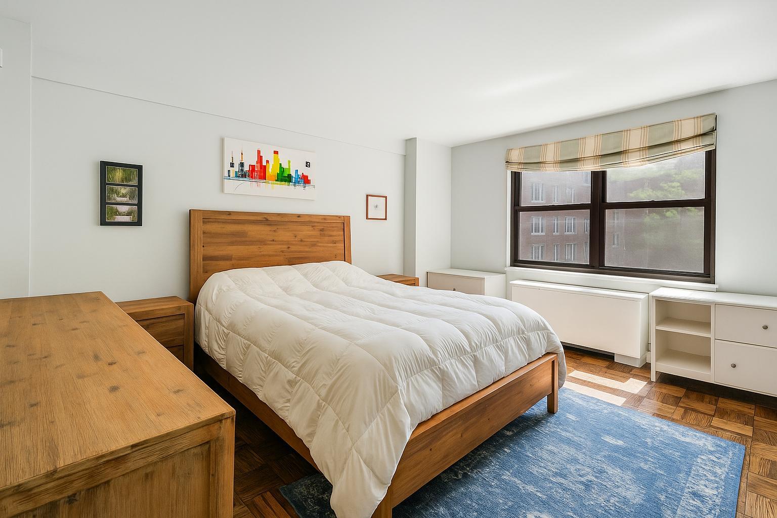 301 East 69th Street, Unit 3M Manhattan, NY 10021 - Photo 4 of 12 a bedroom with a bed and window