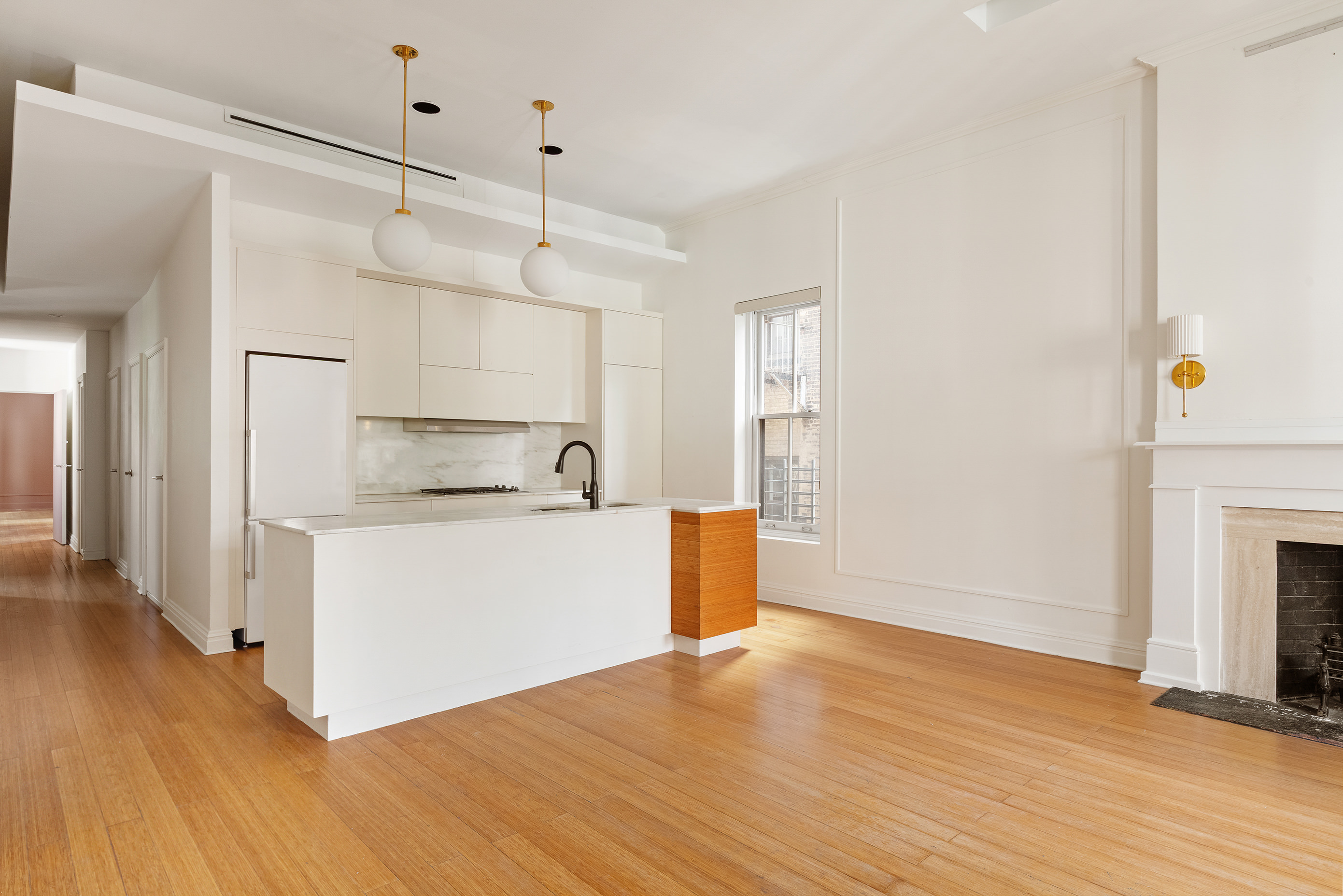 126 East 19th Street Manhattan, NY 10003 - Photo 3 of 13 a view of a kitchen with wooden floor and a sink