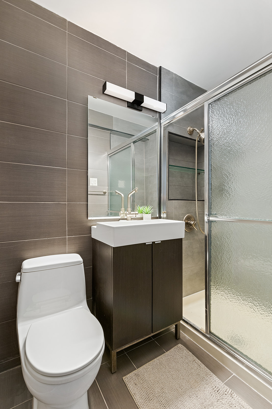 350 Ocean Parkway, Unit 3M Brooklyn, NY 11218 - Photo 8 of 10 a bathroom with a toilet sink and shower