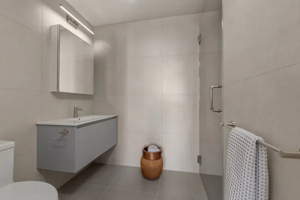 a bathroom with a sink a toilet and a mirror