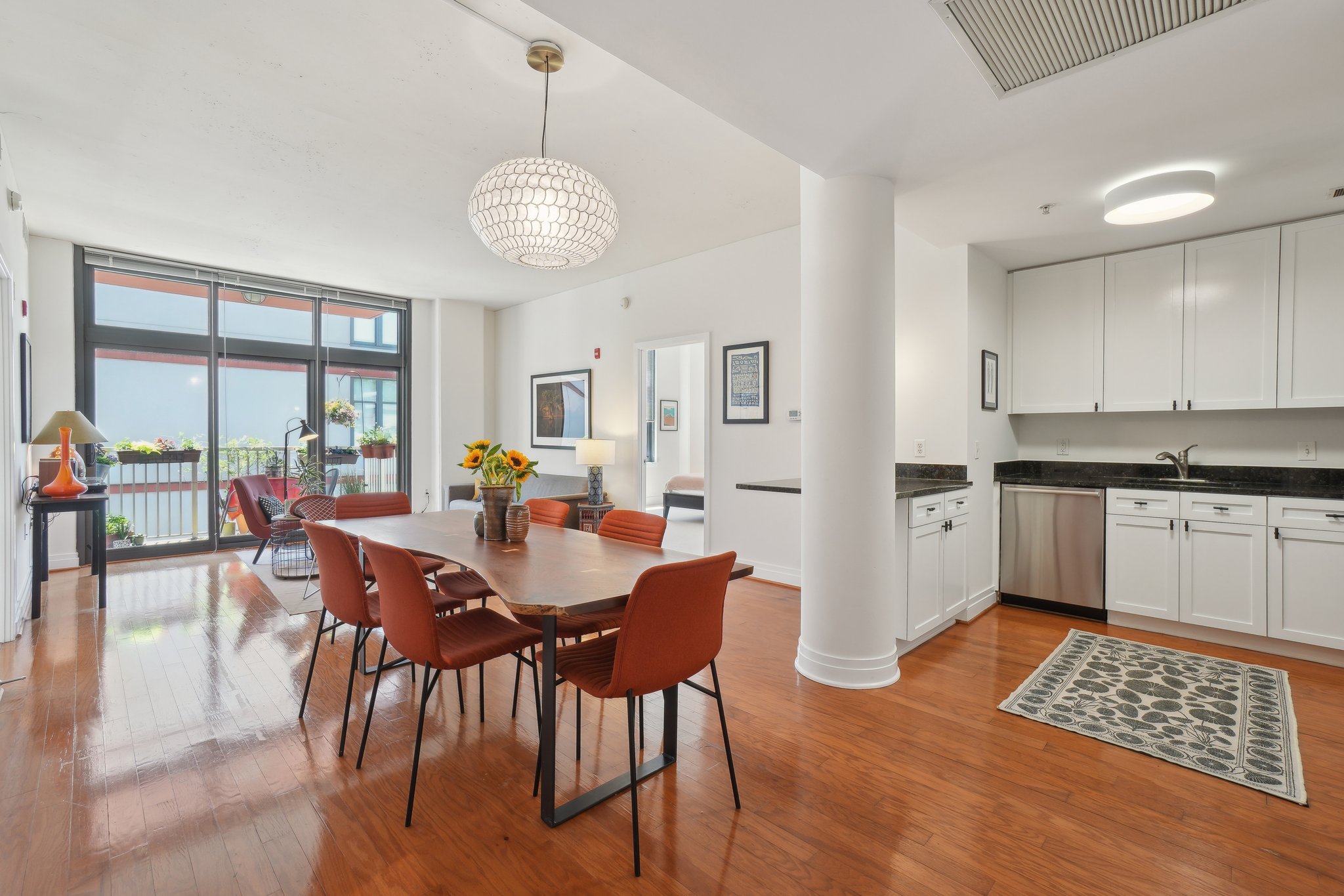 2120 Vermont Avenue Northwest, Unit 309 Washington, DC 20001 - Photo 3 of 26 a view of a dining room with furniture a chandelier and wooden floor