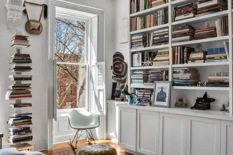 a kitchen with a book shelf