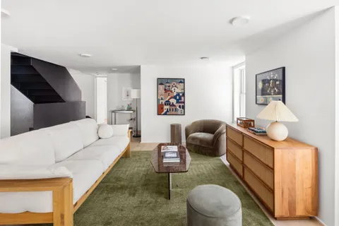 a living room with furniture and a rug