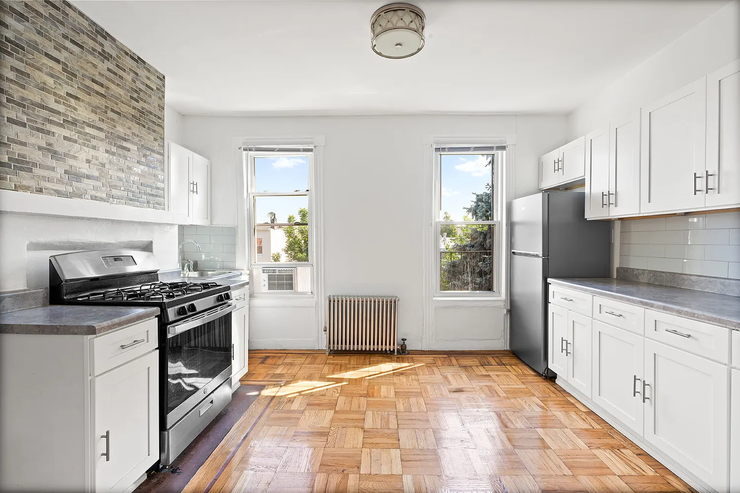 a kitchen with granite countertop a stove top oven sink and cabinets