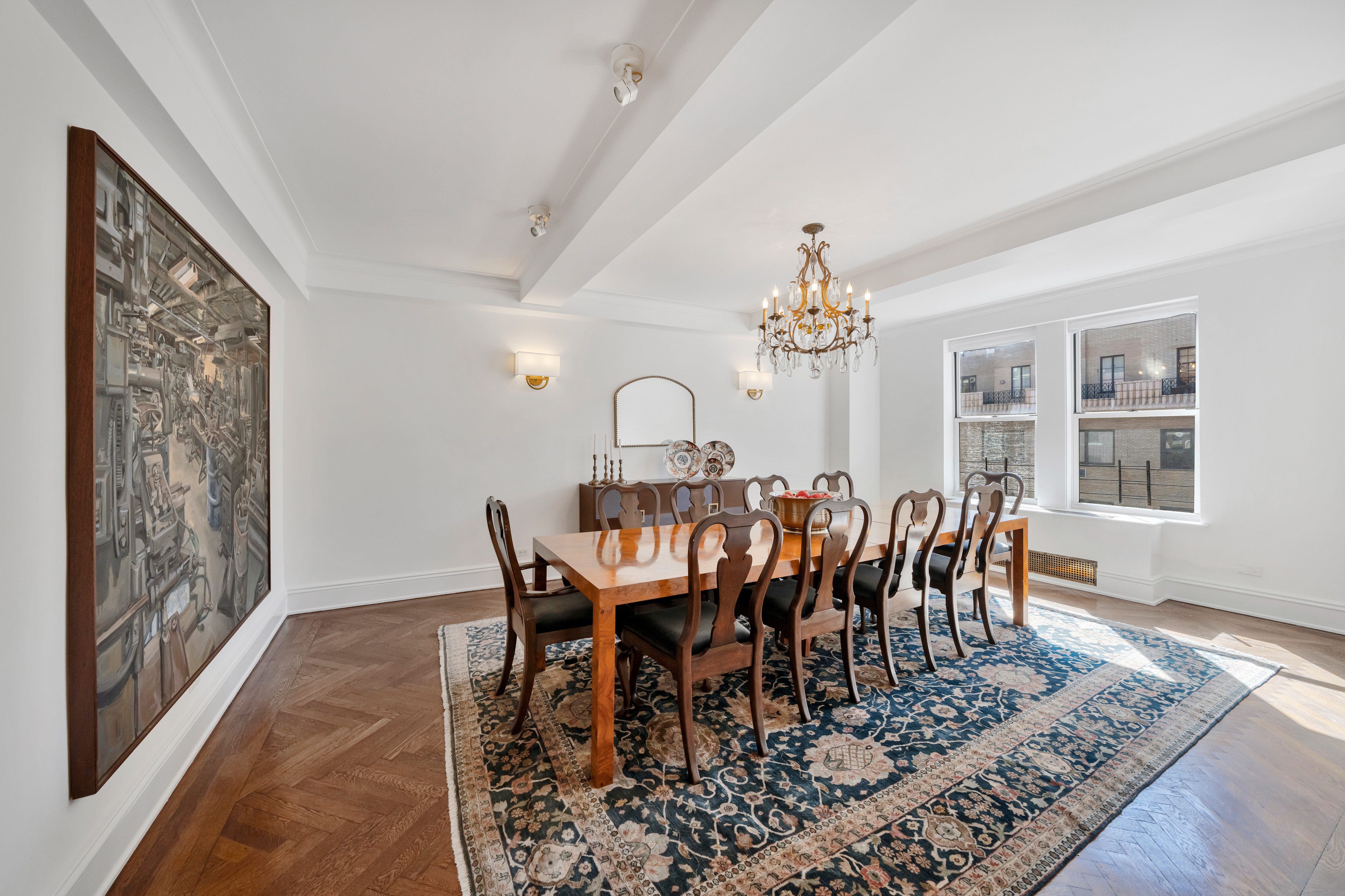 47 East 88th Street, Unit 15A Manhattan, NY 10128 - Photo 5 of 21 a view of a dining room with furniture and chandelier