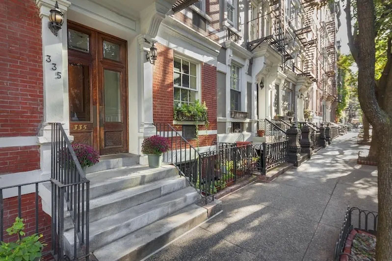 335 West 21st Street, Unit 4FE Manhattan, NY 10011 - Photo 9 of 11 a view of a house with large tree and wooden fence