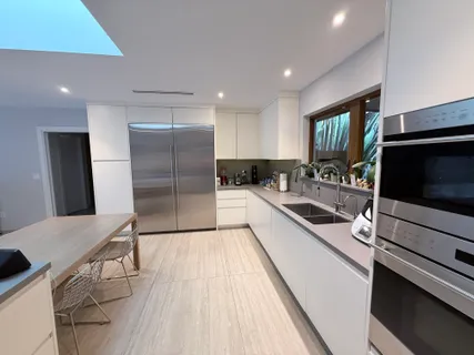 a kitchen with stainless steel appliances a refrigerator and a sink