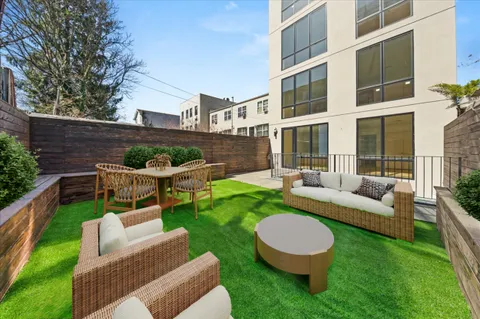 a view of a patio with couches chairs and a yard