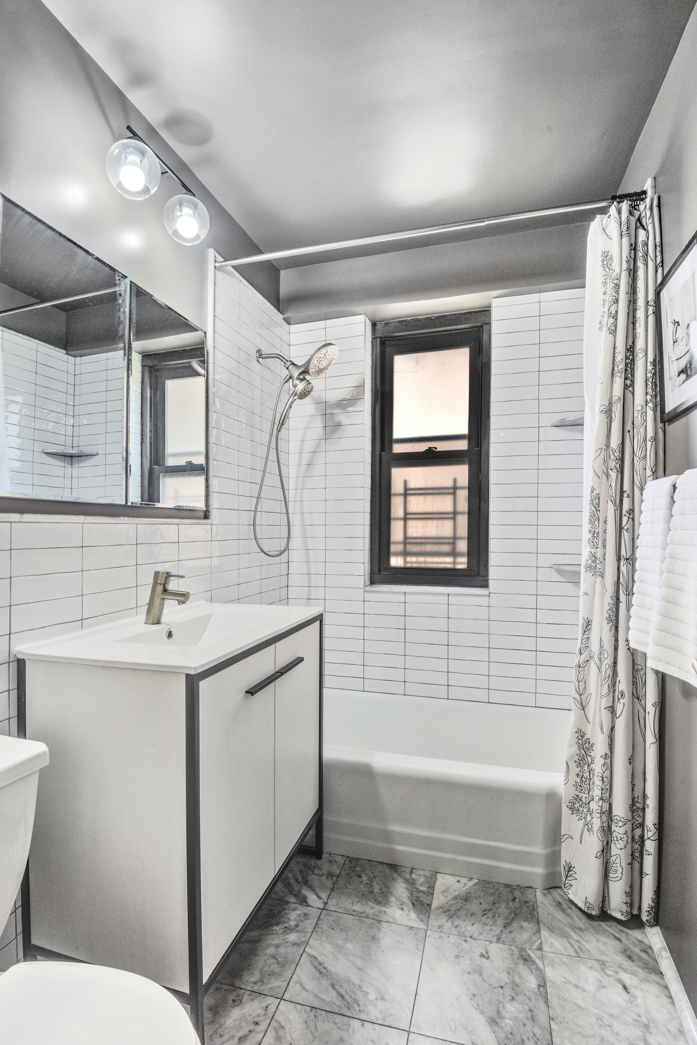 208 East Broadway, Unit J1304 Manhattan, NY 10002 - Photo 10 of 19 a bathroom with a sink a toilet and tub