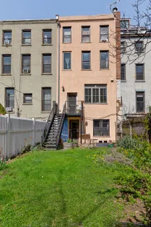 a view of a chair and table in the backyard