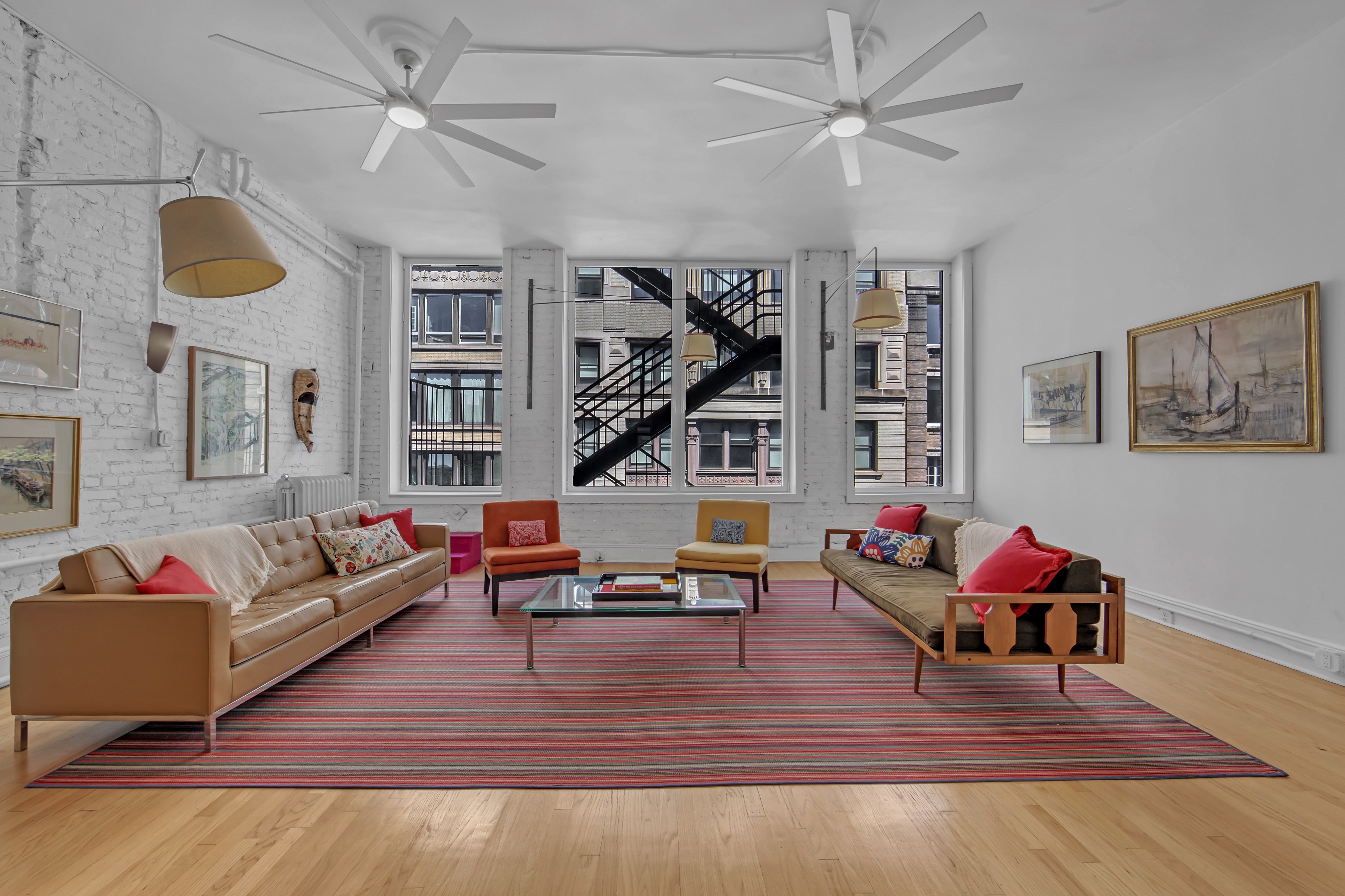56 East 11th Street, Unit 7 Manhattan, NY 10003 - Photo 2 of 18 a living room with furniture and wooden floor