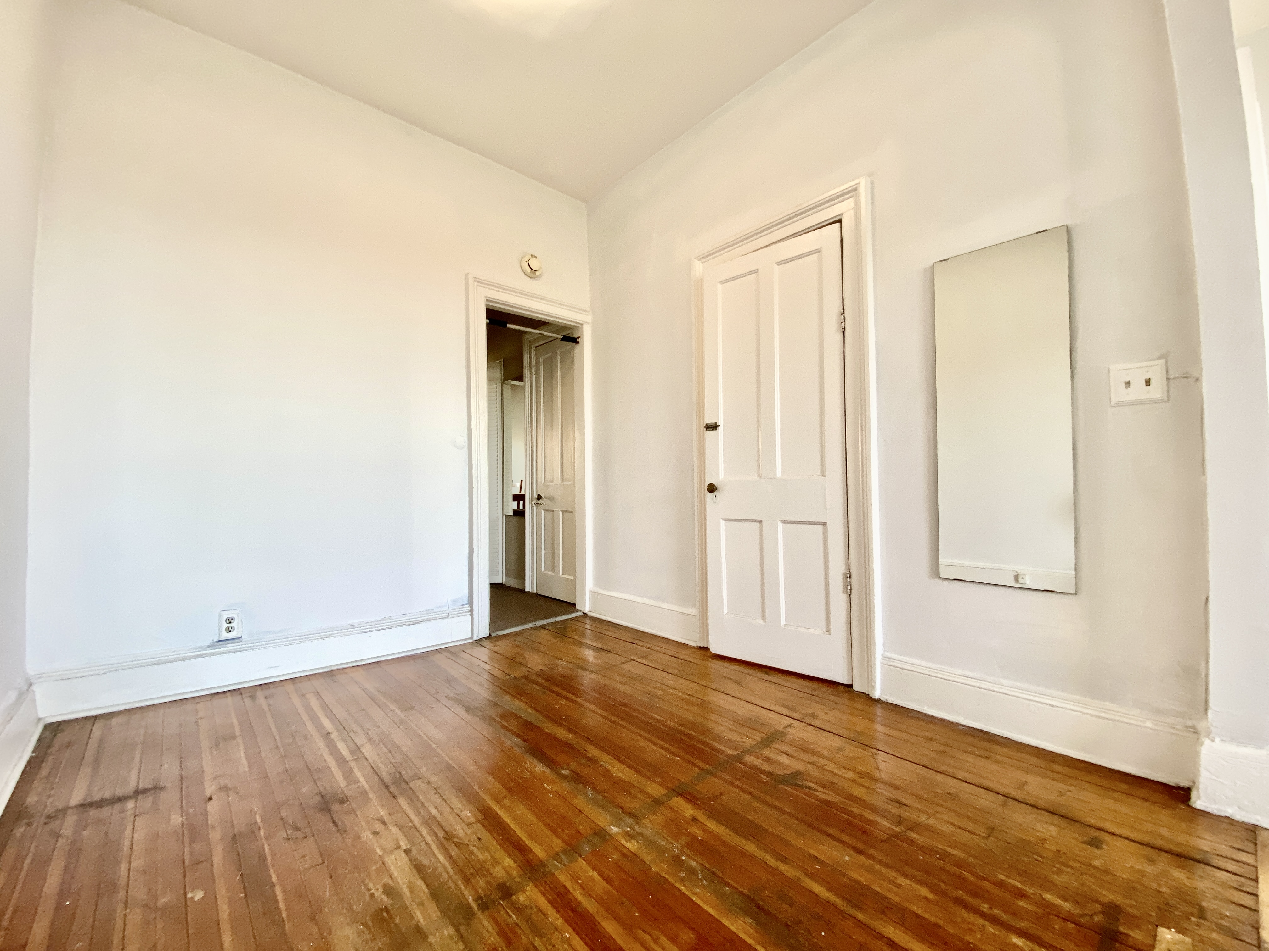 699 4th Avenue, Unit 3 Brooklyn, NY 11232 - Photo 3 of 8 a view of an empty room with wooden floor