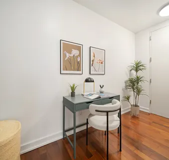 a view of a workspace with furniture and wooden floor