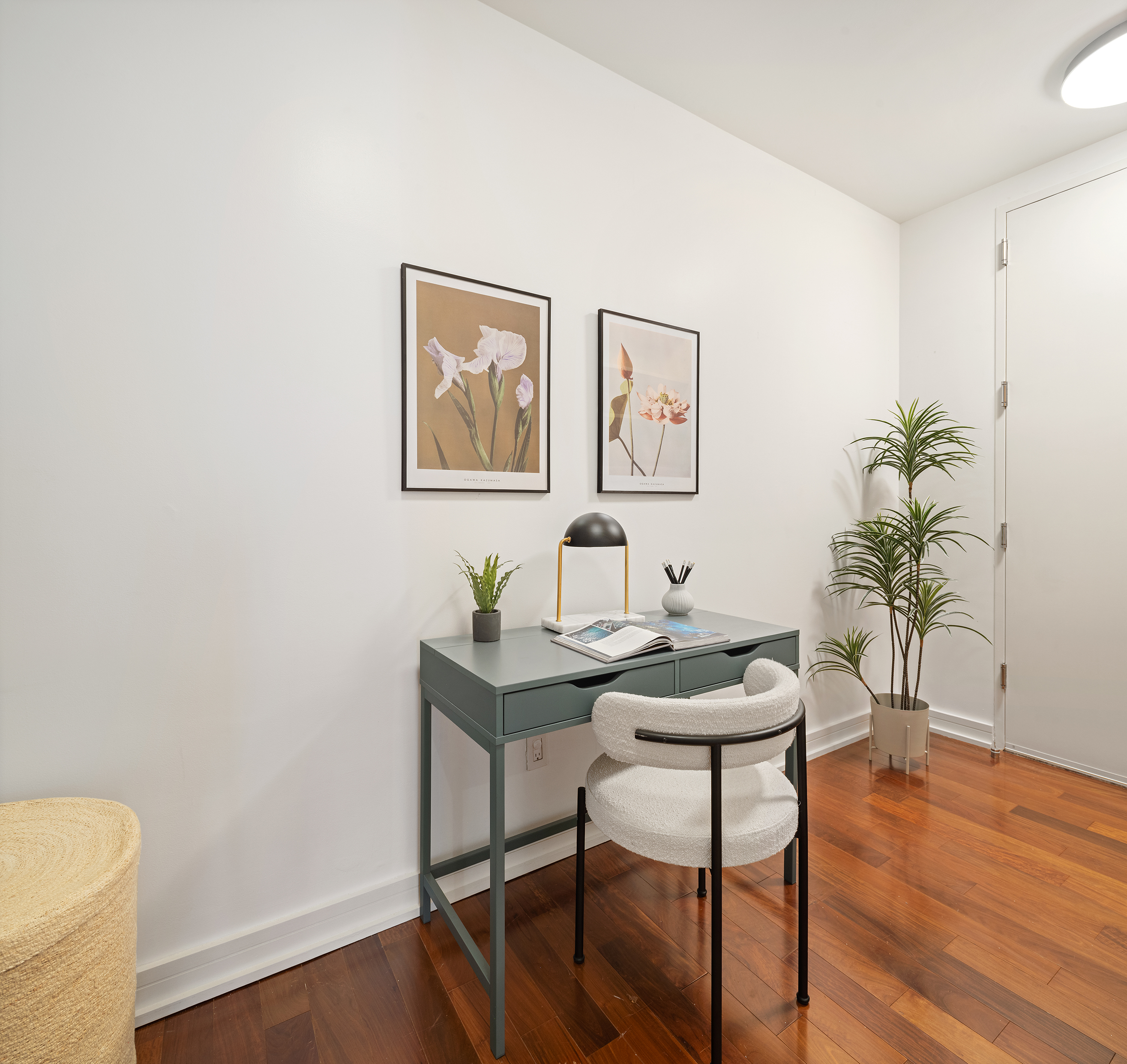 101 Warren Street, Unit 12L Manhattan, NY 10007 - Photo 18 of 28 a view of a workspace with furniture and wooden floor