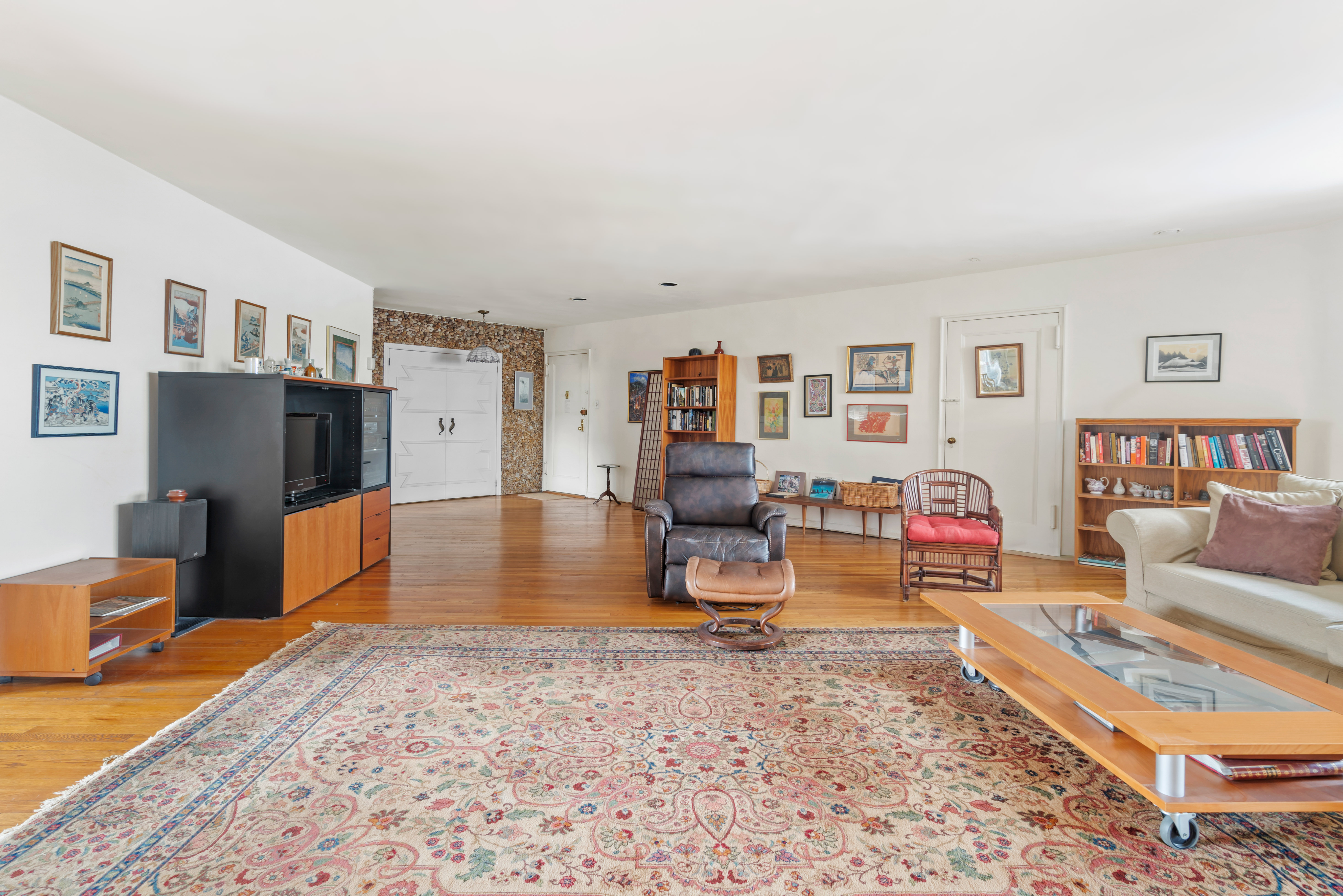 162-01 Powells Cove Boulevard, Unit 4R Queens, NY 11357 - Photo 3 of 12 a living room with furniture and a flat screen tv