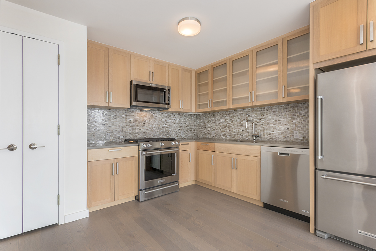 282 South 5th Street, Unit 7F Brooklyn, NY 11211 - Photo 5 of 16 a kitchen with granite countertop cabinets stainless steel appliances and a counter space