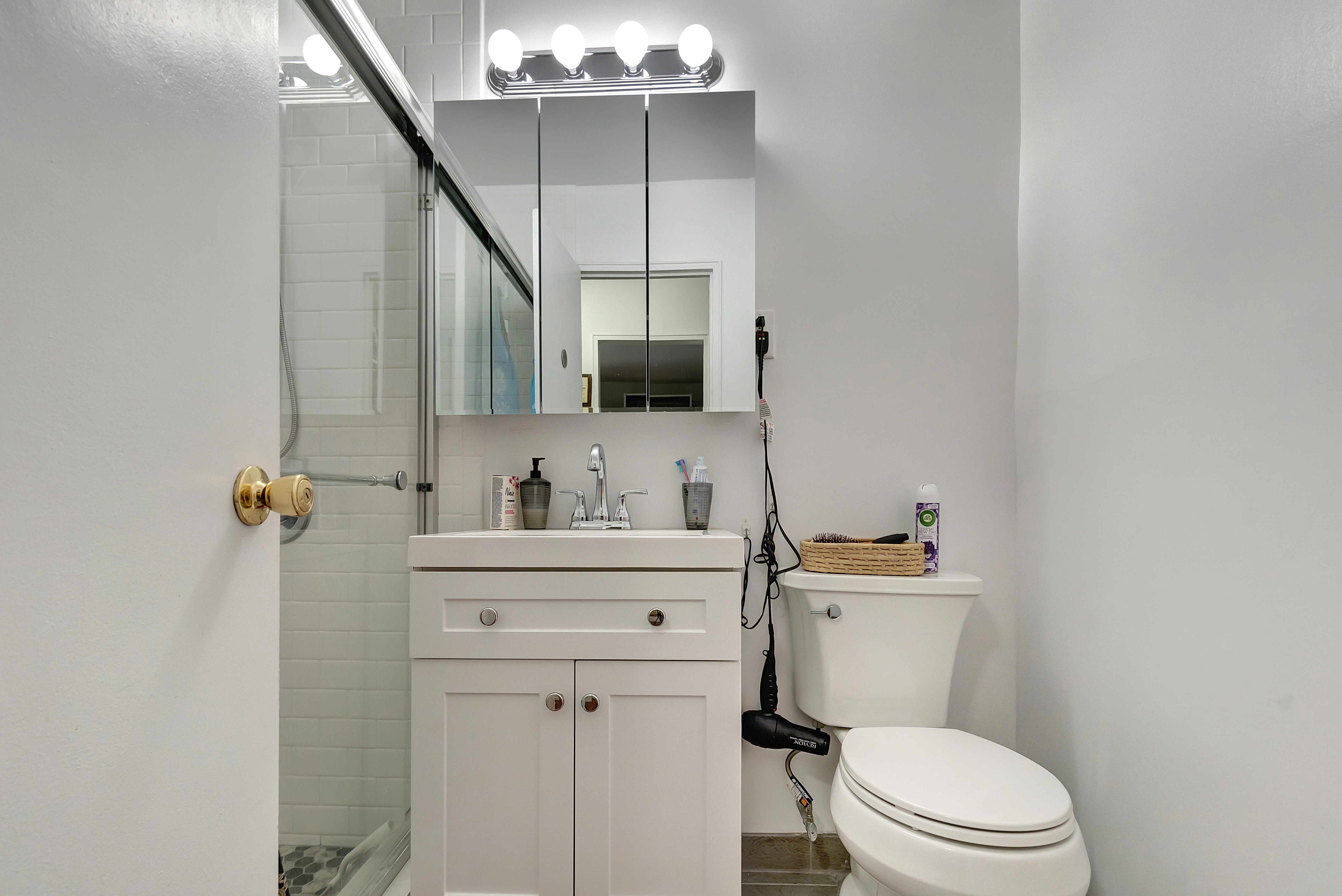 1170 Ocean Parkway, Unit 7A Brooklyn, NY 11230 - Photo 8 of 13 a bathroom with a sink a toilet and mirror