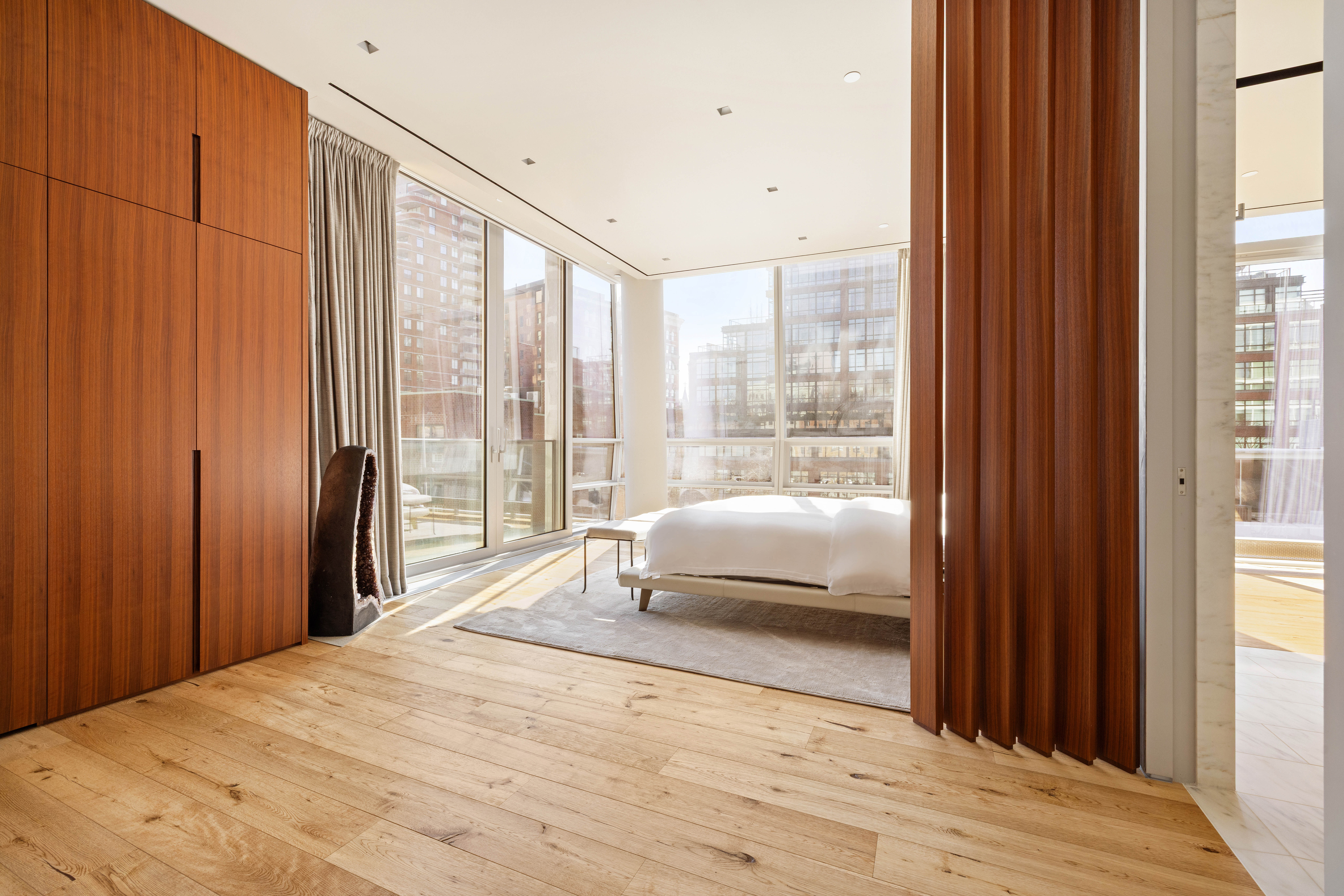 166 Perry Street, Unit 5A Manhattan, NY 10014 - Photo 14 of 25 a bedroom with a bed and a large window