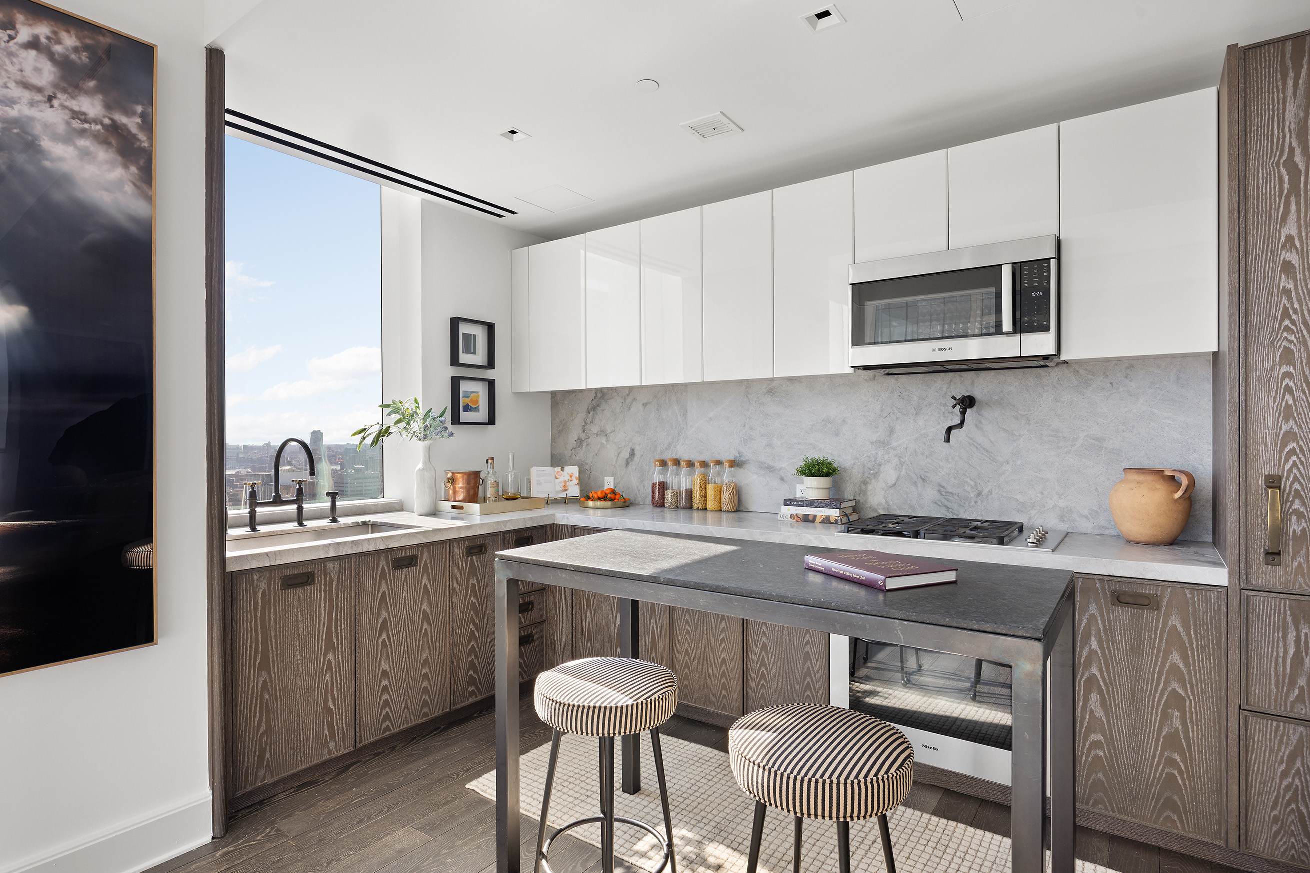 45 East 22nd Street, Unit 32B Manhattan, NY 10010 - Photo 12 of 36 a kitchen with stainless steel appliances a sink a stove a table and chairs