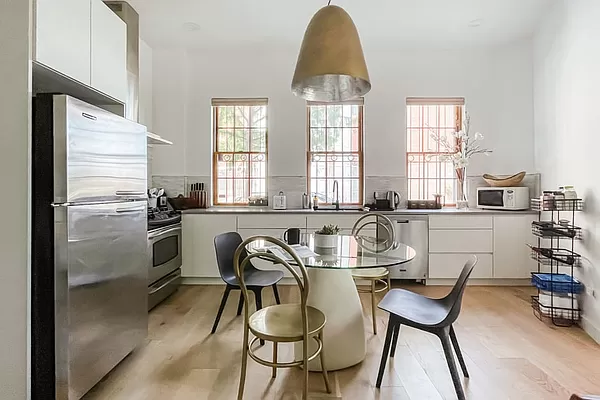 334 Plymouth Street Brooklyn, NY 11201 - Photo 21 of 32 a dining room with furniture a window and stainless steel appliances