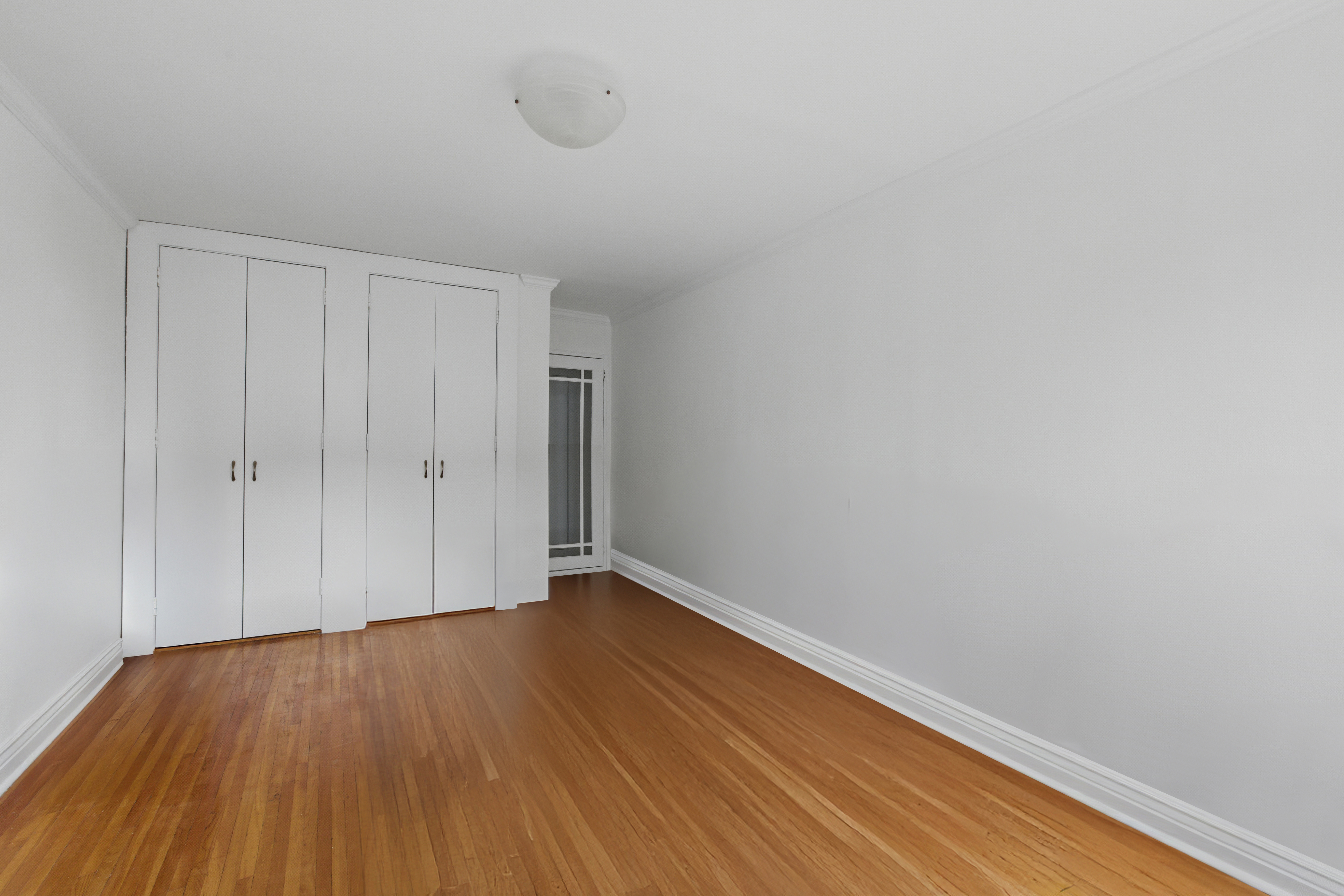 400 East 17th Street, Unit 711 Brooklyn, NY 11226 - Photo 7 of 12 a view of an empty room with wooden floor