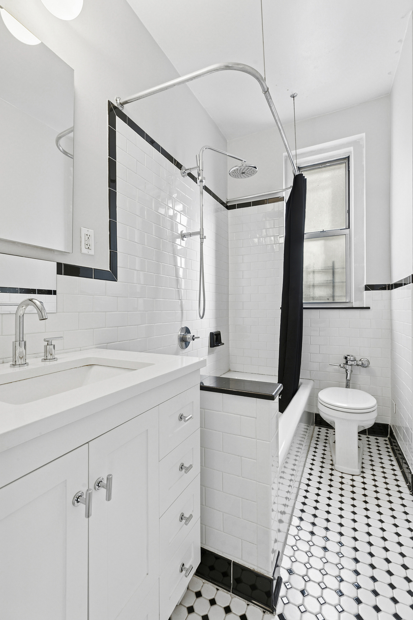 680 West 204th Street, Unit 3E Manhattan, NY 10034 - Photo 5 of 7 a bathroom with a sink a toilet and a mirror