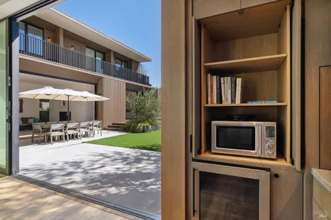 a view of a house with backyard porch and sitting area