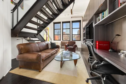 a spacious bedroom with a bed and flat screen tv