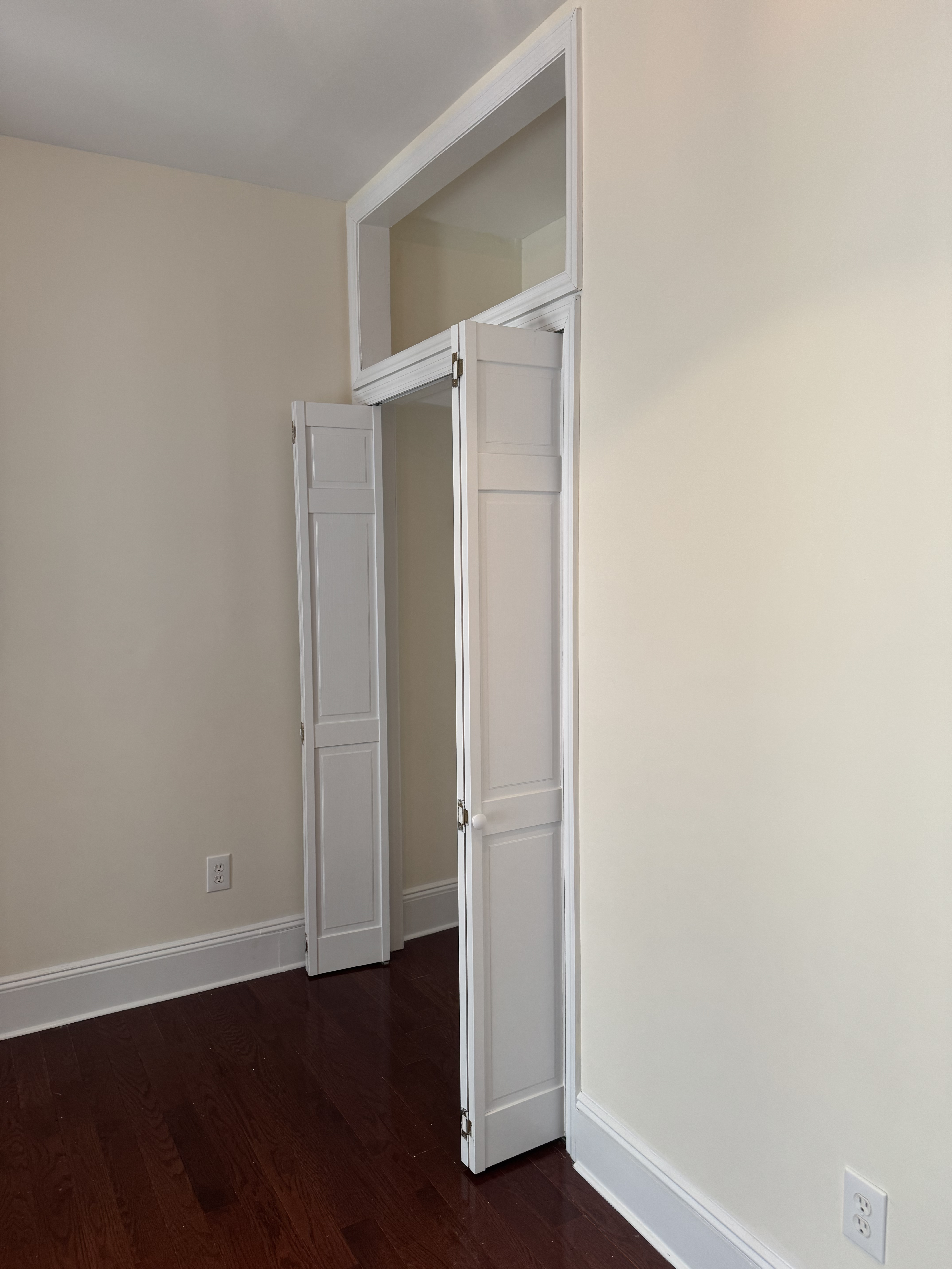 260 Cumberland Street, Unit 15 Brooklyn, NY 11205 - Photo 5 of 10 an empty room with wooden floor and a door